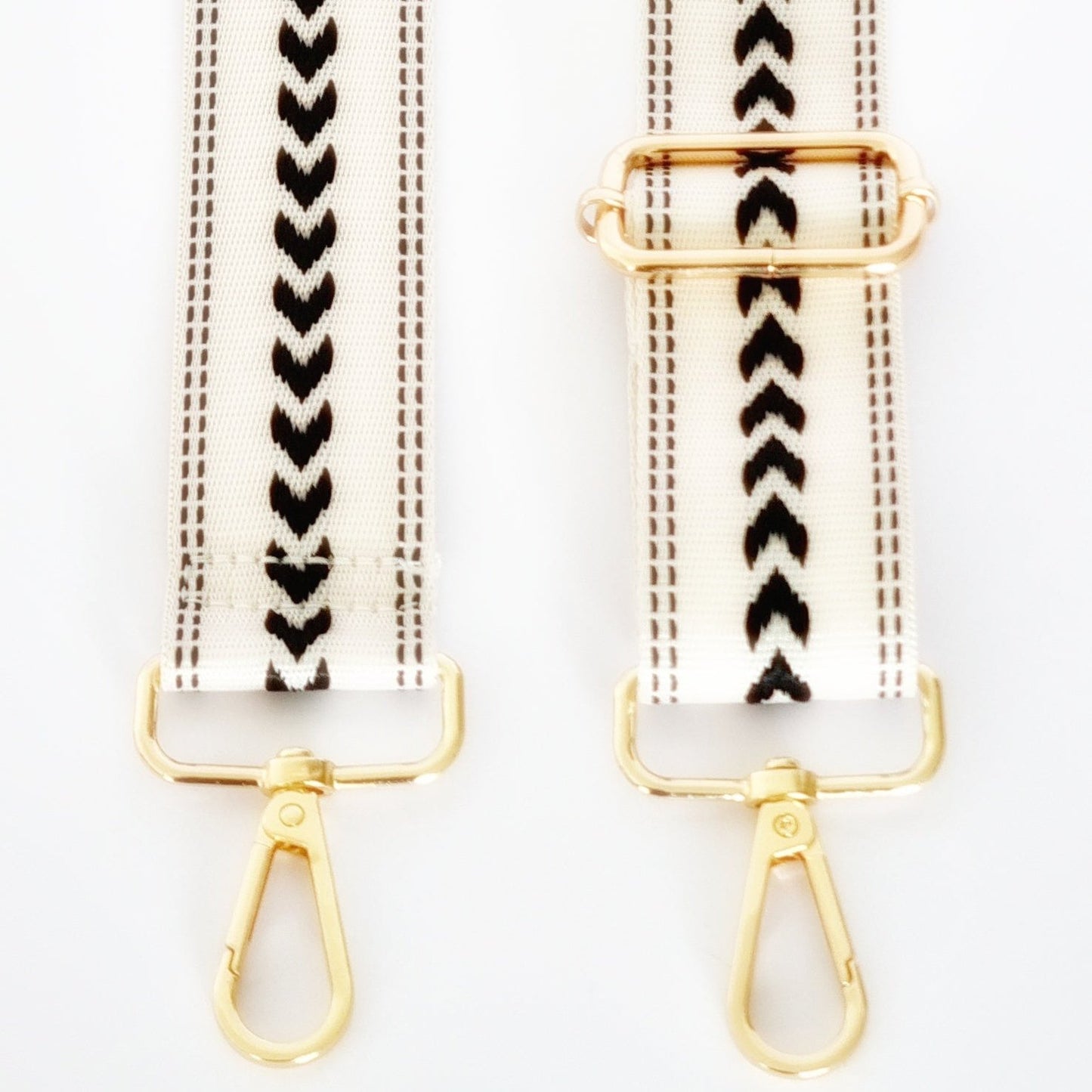 Black and white woven strap with geometric patterns and gold hardware