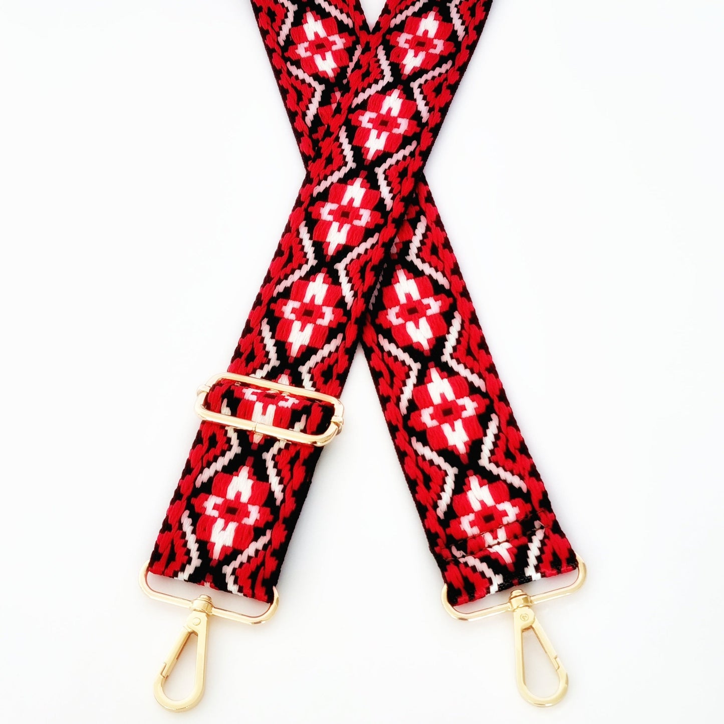 Black and red woven strap with geometric patterns and gold hardware