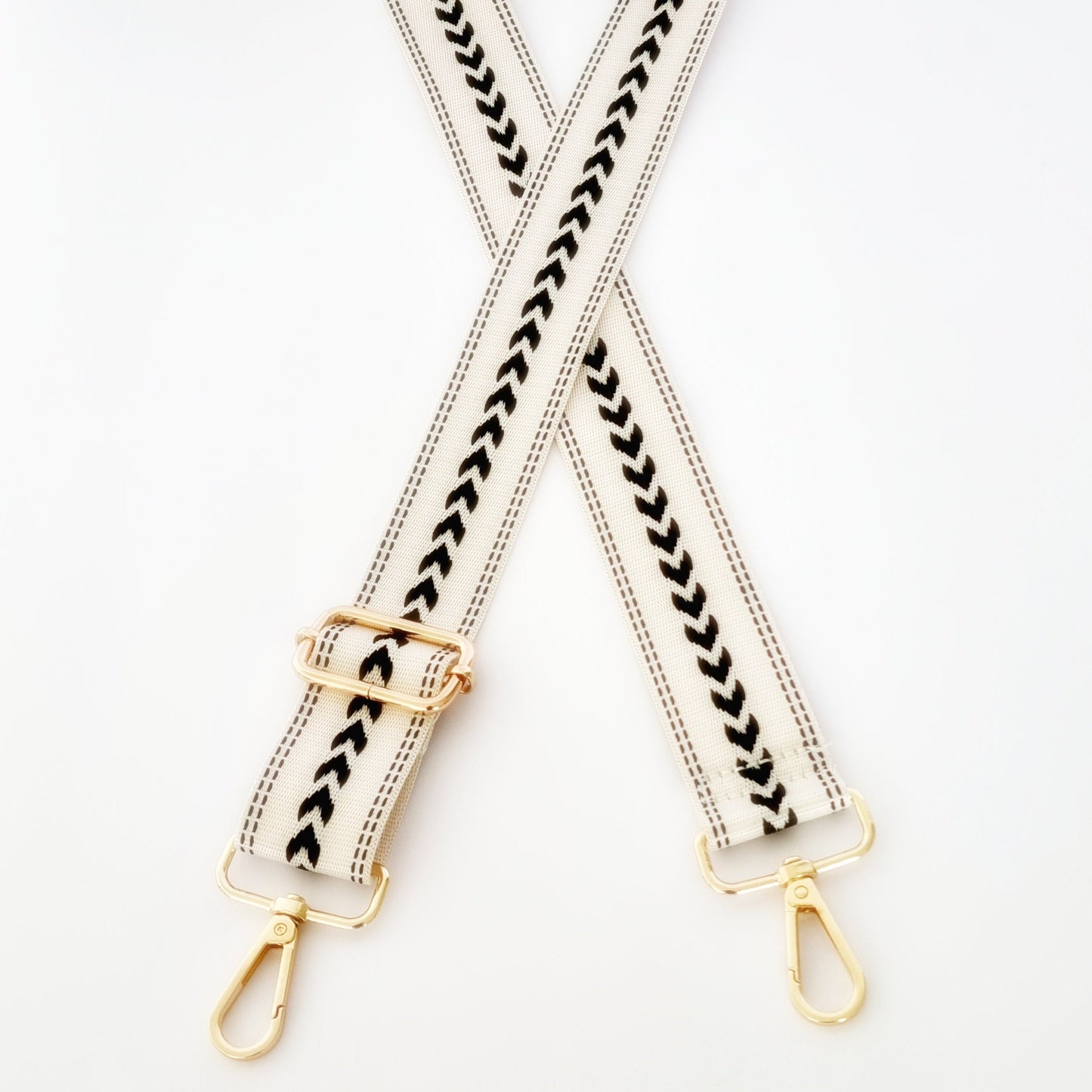 Black and White woven strap with geometric pattern and gold clasp hardware