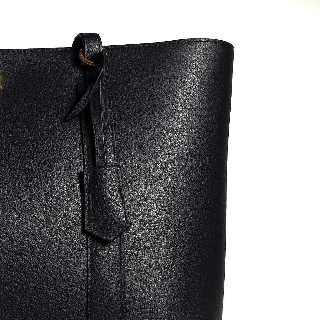 Close-up of a black leather tote bag with a tag on a white background