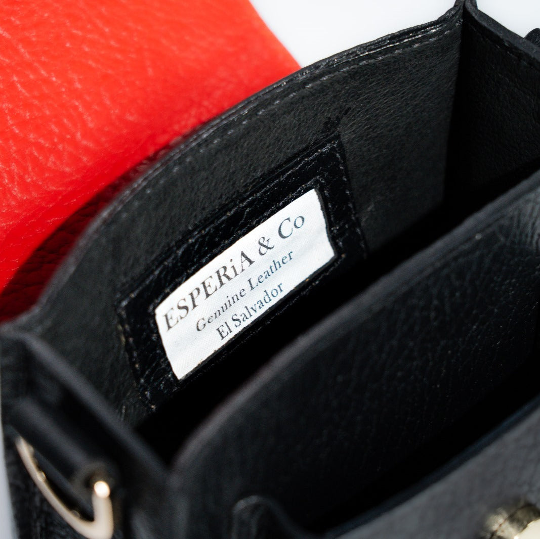 Black leather handbag with a visible brand label on a white background