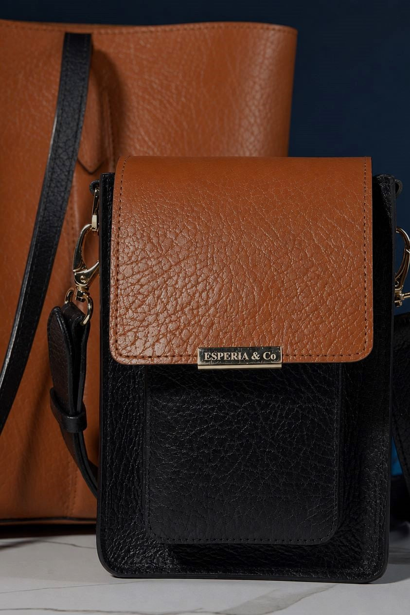 Brown and black leather crossbody bag with 'Esperia & Co' label on a dark background