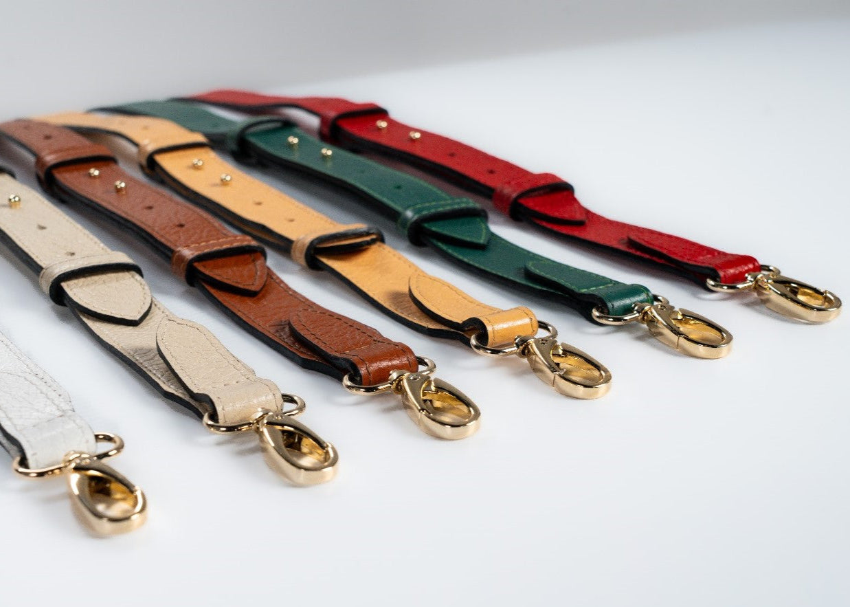 Set of leather straps in various colors with gold hardware for handbags