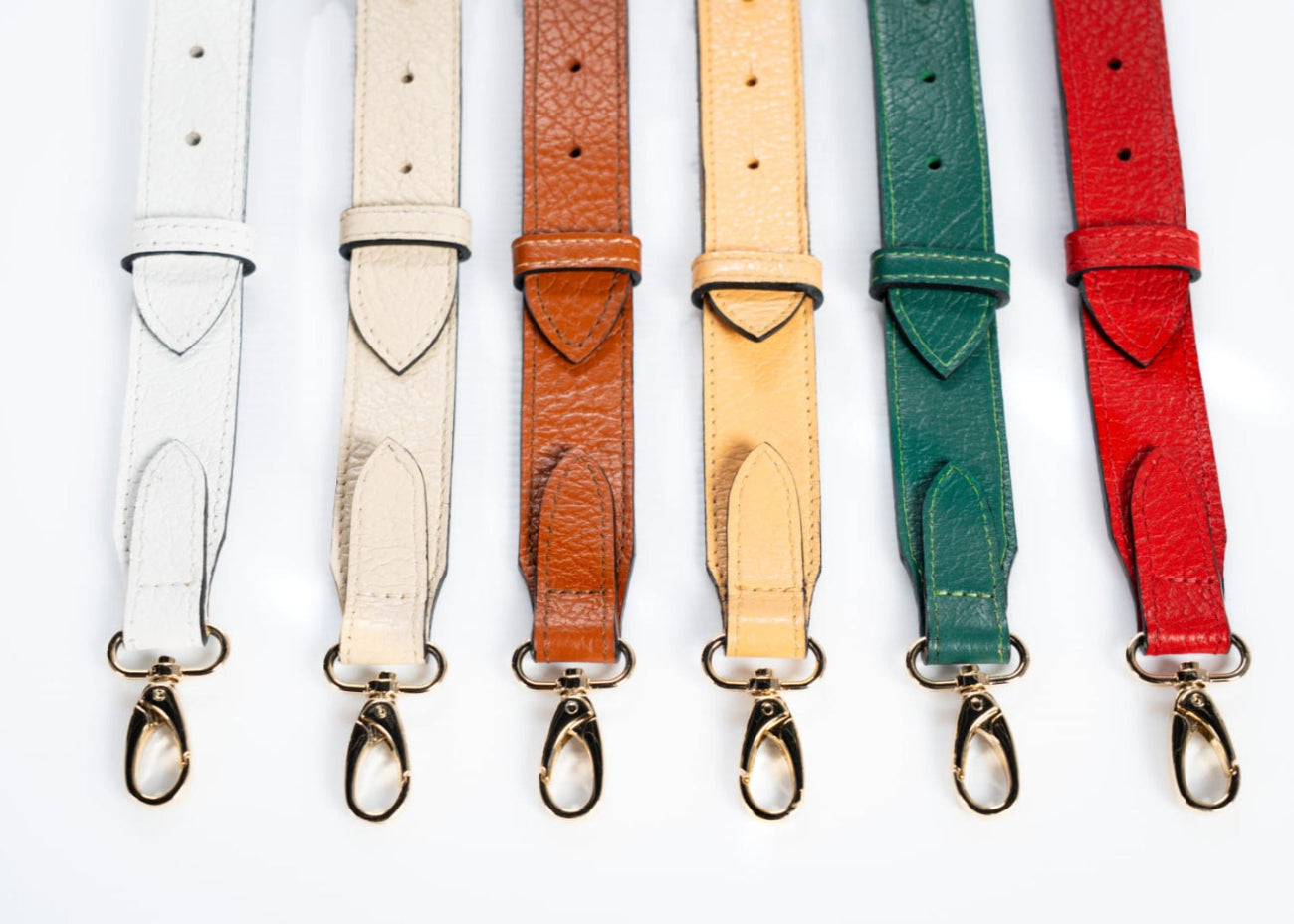 Leather straps in different colors with gold clasp hardware for handbags