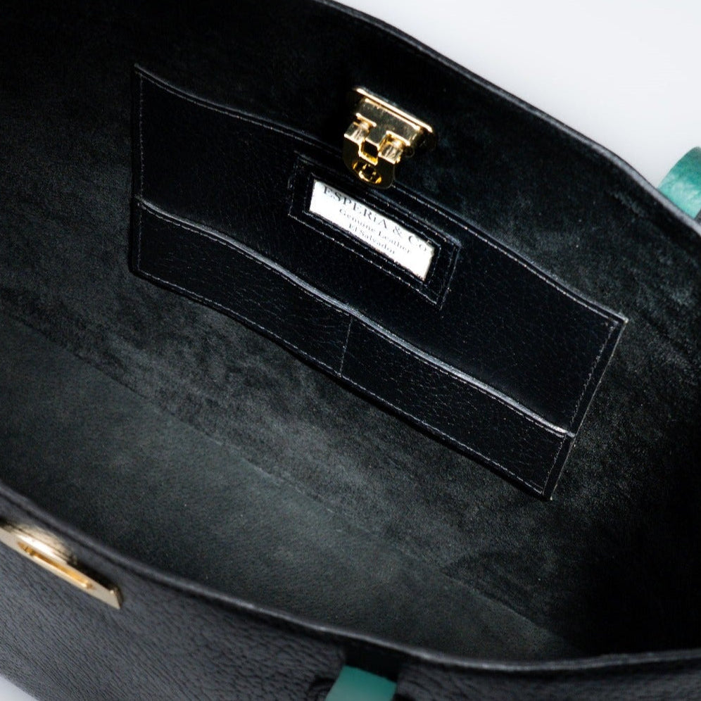 Black tote handbag with a visible brand label and gold hardware